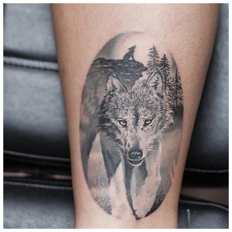 Mga tattoo ng Wolf sa guya ng isang lalaki